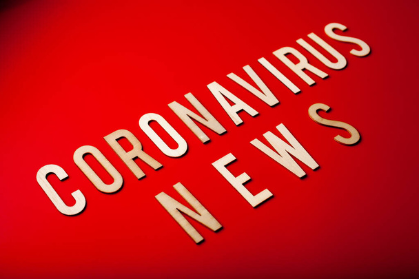 coronavirus news word text wooden letter on red background corona virus covid-19 - Zdjęcie, obraz