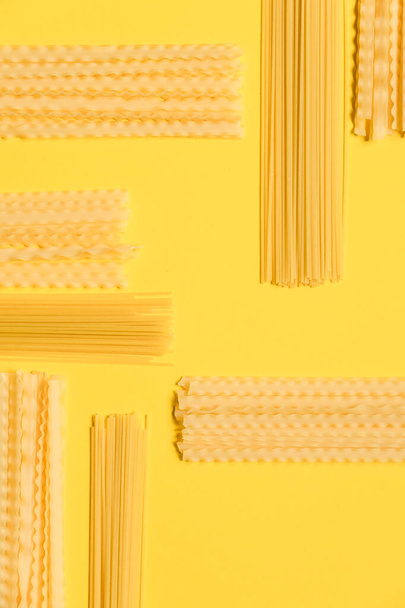 varieties of pasta on a yellow background - 写真・画像