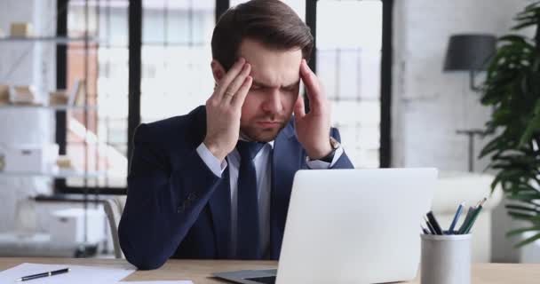 Exhausted stressed ceo suffering from headache at workplace - Footage, Video