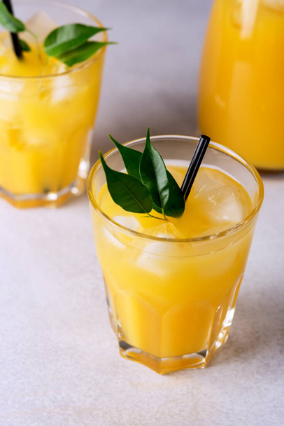 Tasty and Refreshing Orange Juice in Glass with Black Straws on Light Gray Background Fresh Ripe Oranges Vertical - Fotoğraf, Görsel