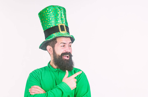 Look at that. Bearded man celebrating saint patricks day. Hipster in leprechaun hat and costume pointing his finger. Irish man with beard wearing green. Happy saint patricks day, copy space - Photo, Image