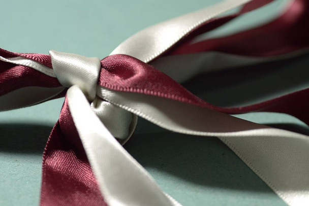A closeup shot of a two colored knot of a ribbon - Фото, зображення