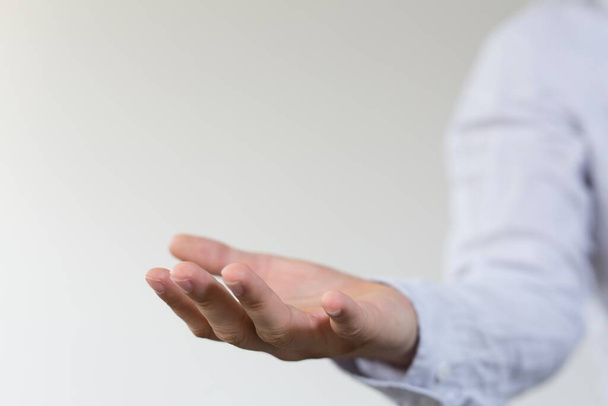 A closeup shot of the open hand of a businessman at a presentation - Фото, изображение