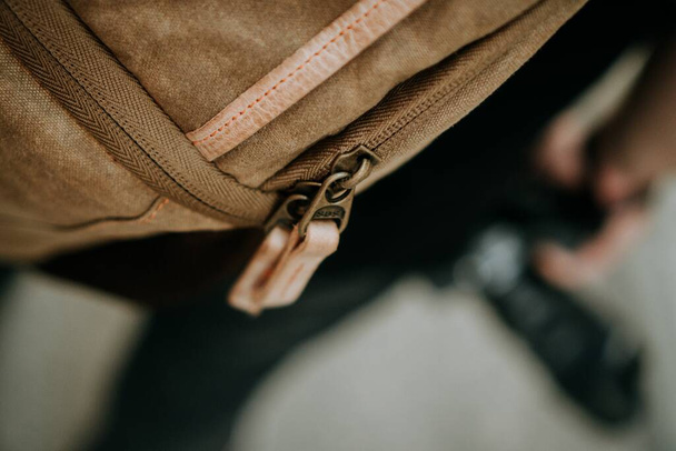 A closeup shot of the zipper pull tabs of a brown canvas camera utility bag - Foto, afbeelding