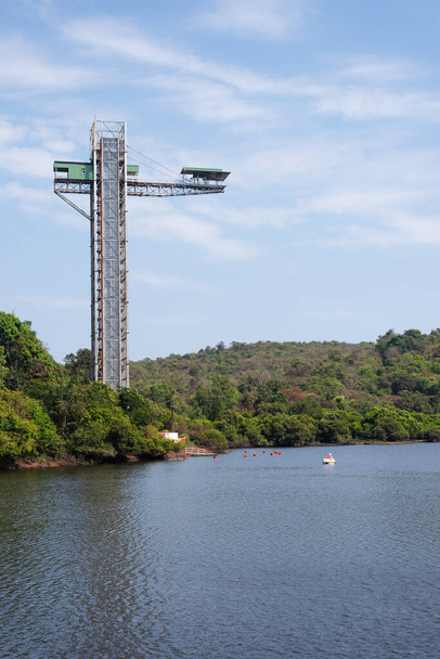 Long exposure Landscape image of Mayem Lake in Goa with the bungee jumping structure on display, Jumpin heights bungee jumping landscape view in Goa, Boat peddling in Goa - Photo, Image