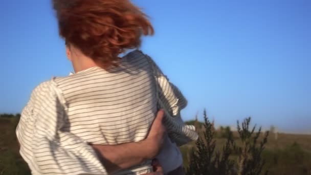 Ein verliebter Mann fängt eine Frau, umarmt sie, dreht sich und lächelt - Filmmaterial, Video