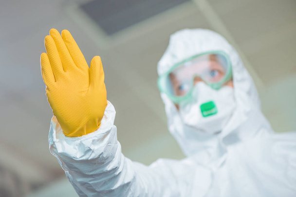 Female epidemiologist gesturing stop sign in hospital quarantine, selective focus - Valokuva, kuva