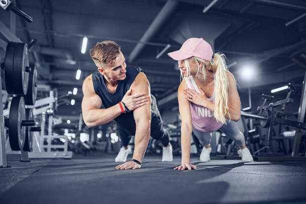 Man and woman strengthen hands at fitness training - Φωτογραφία, εικόνα