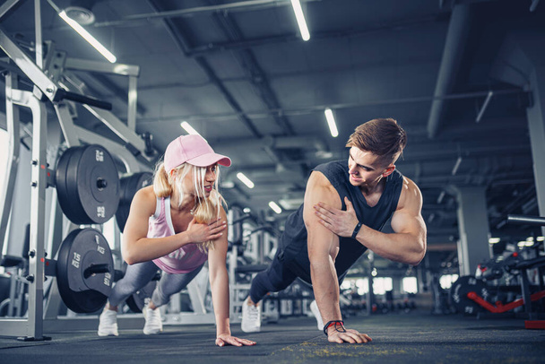 Man and woman strengthen hands at fitness training - Foto, Imagem