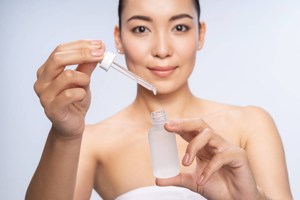 Happy Asian woman getting special skin treatment - Foto, immagini
