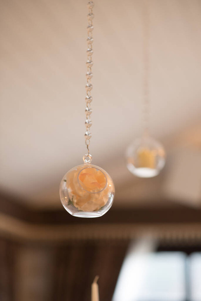Wedding decor in the restaurant. Beautiful hanging round balls with flowers - Photo, Image