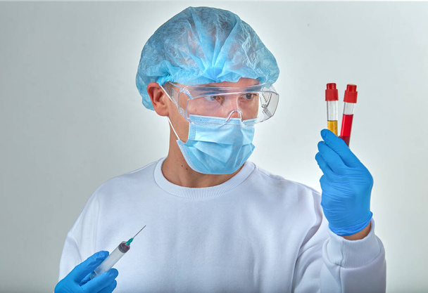 Doctor in mask performing blood test for coronavirus COVID19, HIV, ebola or other dangerous infection. Medical background, instruments, template, wallpaper. Coronavirus disease concept - Zdjęcie, obraz