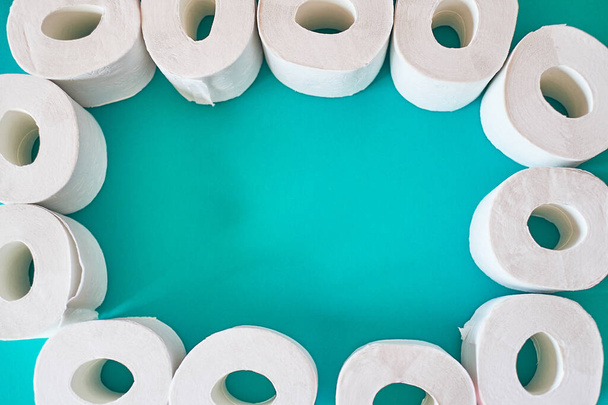Toilet paper on a turquoise background.Essential goods for hygiene. - Foto, Bild