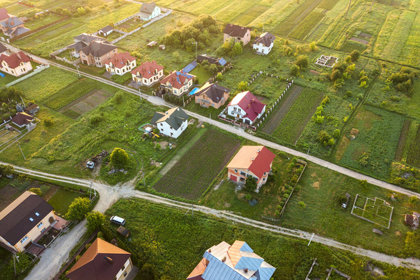 Aerial landscape of small town or village with rows of residential homes and green trees. - Photo, Image