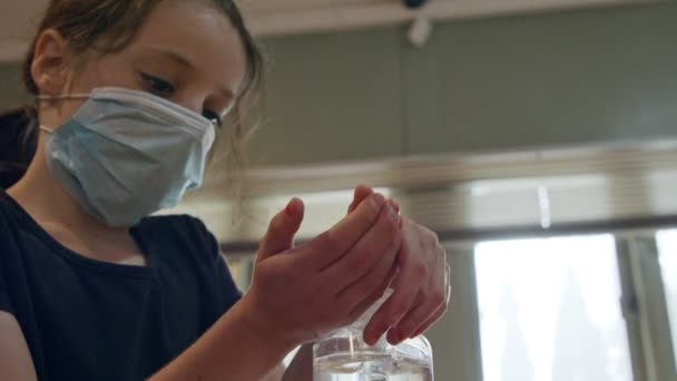 Corona pandemic - Girl using hand sanitizer to prevent coronavirus spread - Materiał filmowy, wideo