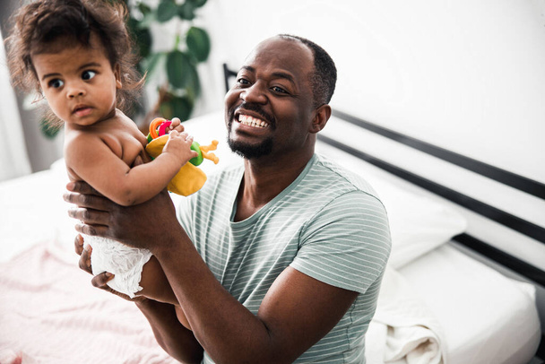 Happy father holding cute newborn baby and smiling - Valokuva, kuva