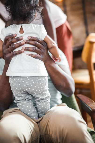Afro American man is holding newborn daughter - Fotoğraf, Görsel