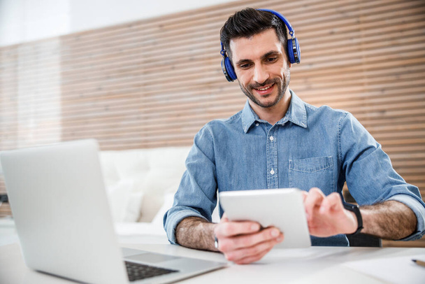 Happy male in headphones with gadgets stock photo - Zdjęcie, obraz