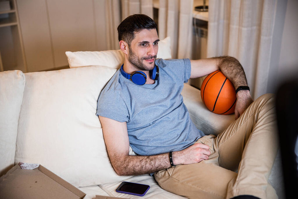Cheerful man relaxing at home with video games stock photo - Photo, image