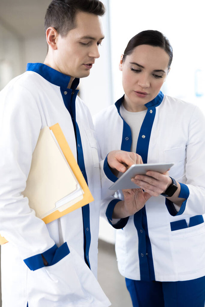 Medical workers using modern gadget in clinic - Fotoğraf, Görsel