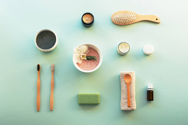 Top view hygiene items and natural cosmetics on blue background. Beauty, spa and wellness concept. Flat lay, copy space. - Valokuva, kuva