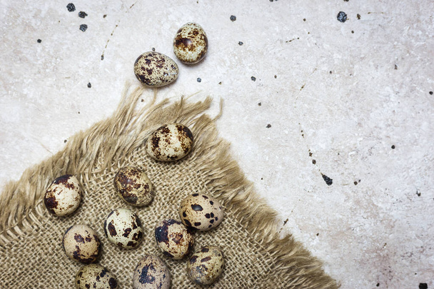 Fresh organic quail eggs on light background. Top view, copy space. Easter holidays concept. - Фото, зображення