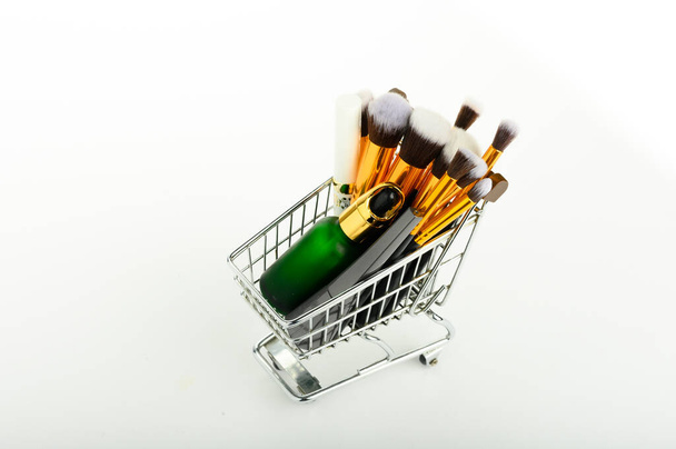 makeup brush on shopping chart, isolated white background. - Photo, Image