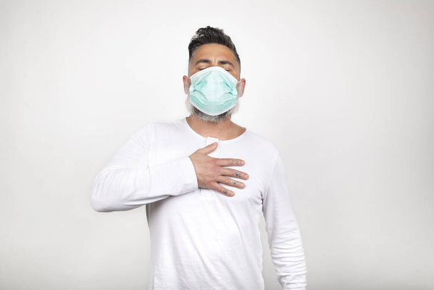 Front view of sick man presenting symptoms of coronavirus on white background. - Photo, Image