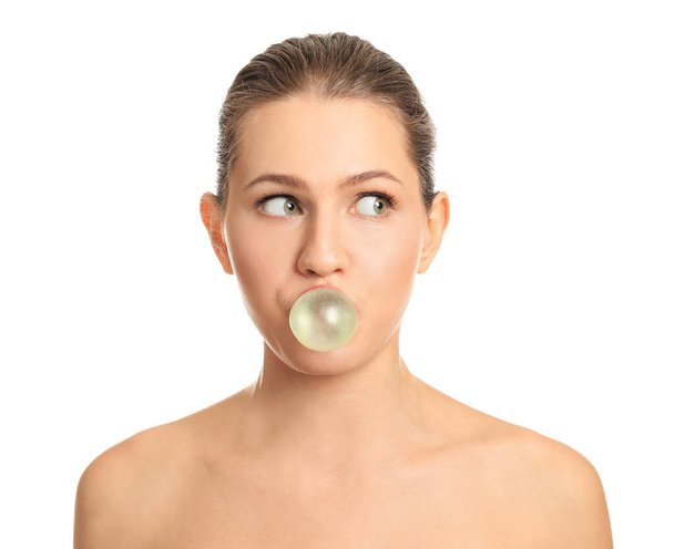 Beautiful young woman with chewing gum on white background - Photo, Image