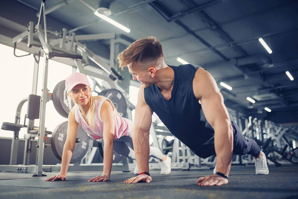 Man and woman strengthen hands at fitness training - Photo, Image