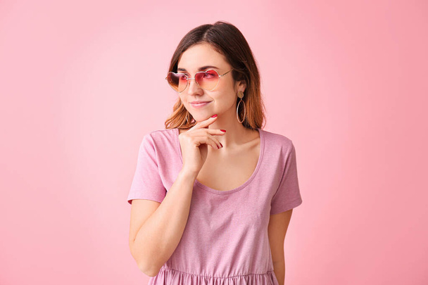 Young woman with stylish sunglasses on color background - Photo, Image