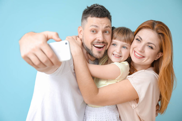 Family taking selfie on color background - Zdjęcie, obraz