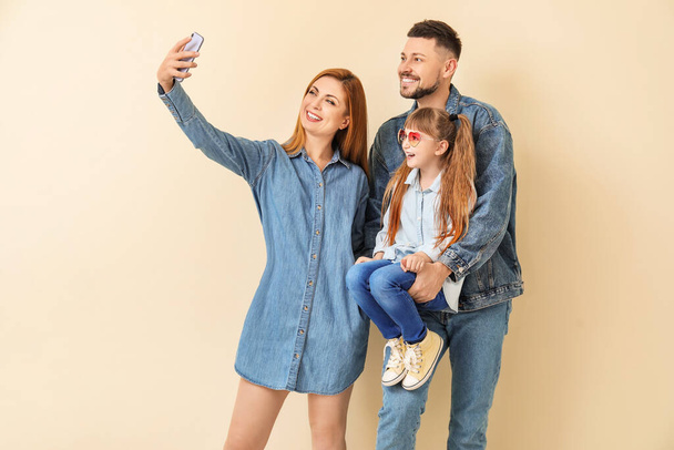 Family taking selfie on light background - Foto, Imagen