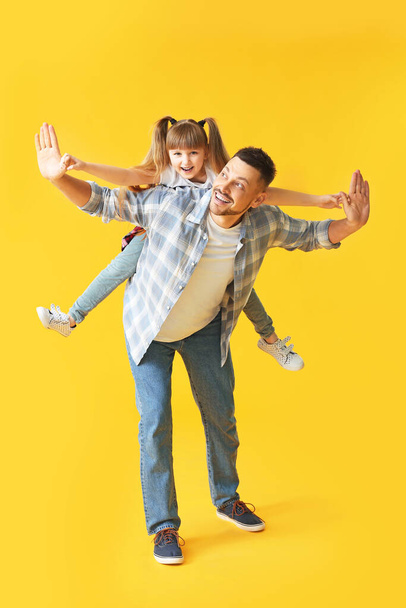 Happy father and his little daughter on color background - Photo, Image