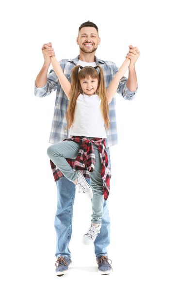 Father and his little daughter dancing against white background - Fotografie, Obrázek