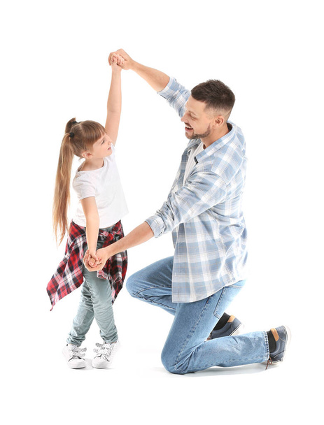 Father and his little daughter dancing against white background - Foto, Imagem