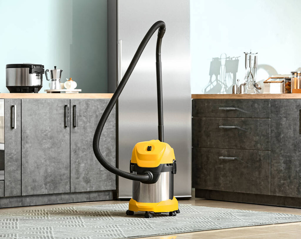 Modern vacuum cleaner in kitchen - Zdjęcie, obraz
