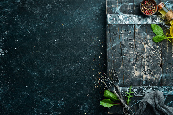 Black stone food background. Vegetables and spices on black old table. - Photo, image