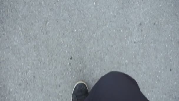 man in black sneakers is walking on the asphalt. - Footage, Video