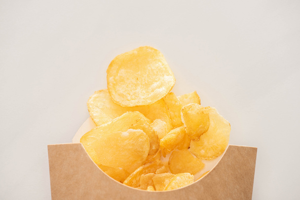 top view of crunchy potato chips isolated on white  - Zdjęcie, obraz