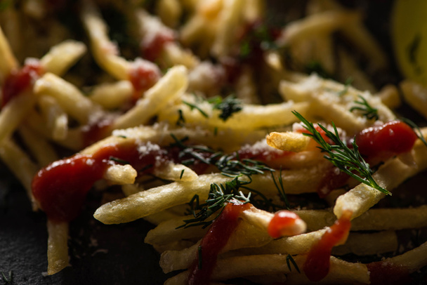 close up of tasty french fries with ketchup, salt and dill  - Foto, imagen