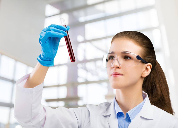 young female scientist in protective uniform working in laboratory - Zdjęcie, obraz