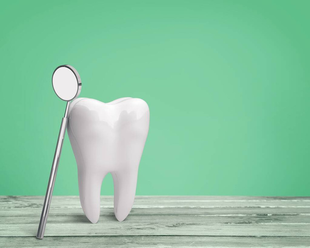 μεγάλο δόντι μοντέλο και οδοντίατρος καθρέφτης  - Φωτογραφία, εικόνα