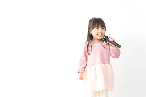 little girl holding microphone - Фото, изображение