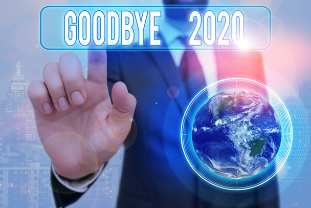Writing note showing Good Bye 2020. Business photo showcasing express good wishes when parting or at the end of last year Elements of this image furnished by NASA. - Photo, Image