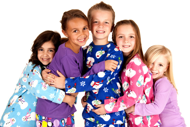 happy children in winter pajamas hugging each other - Photo, image