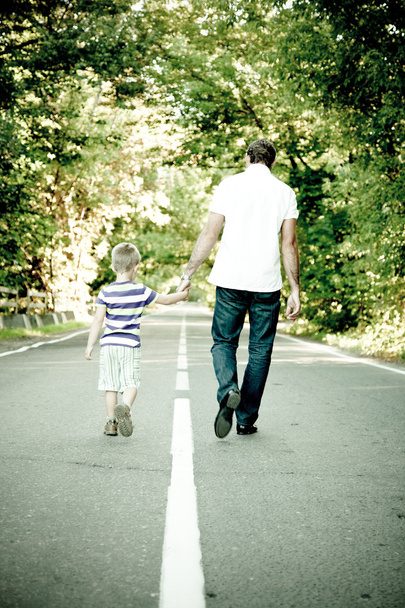 Father with his son go away hand to hand - 写真・画像