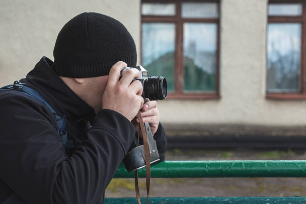 photographer takes photo on camera outdoors - Фото, изображение