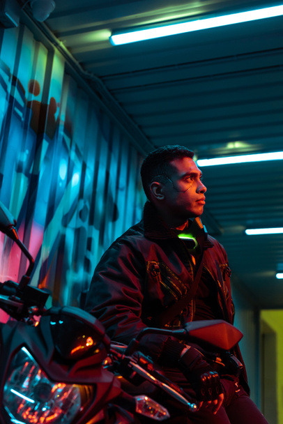 selective focus of mixed race cyberpunk player near motorcycle  - Fotoğraf, Görsel