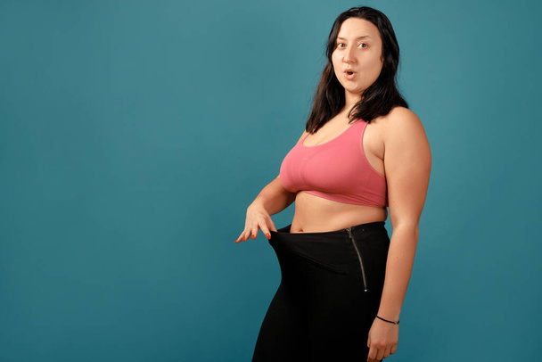 Happy plus size positive woman. Happy body positive concept. I love my body. Attractive overweight woman posing on camera. Before and after from fat to slim concept - Photo, image